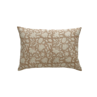 A lumbar pillow with a beige background with a cream colored floral print foreground. 