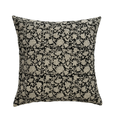 A decorator throw pillow cover in hand blocked printed fabric. The background of the fabric is black and the foreground is gray/white botanical print. 