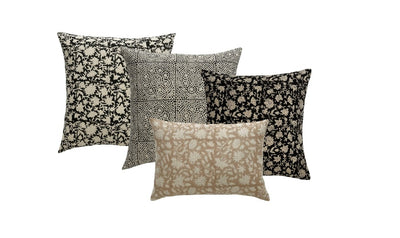A composite of 4 decorator throw pillows with different fabrics. 