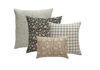 A collection of four decorator throw pillows, each in a different fabric color and print. 